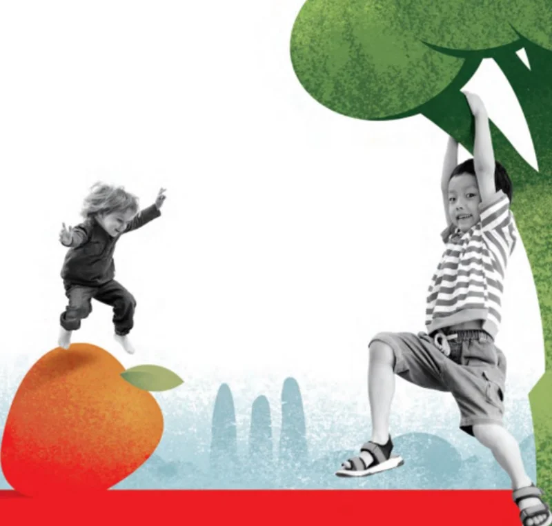 Artistic picture of two children at play in a cartoon landscape. One jumps over an apple, the other hangs from a tree that looks like it might be brocolli.